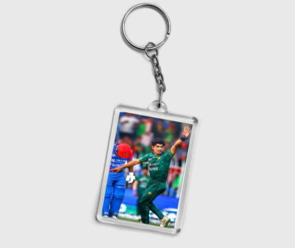 Introducing the captivating "Naseem Shah Keychain Design" by Perfect Prints - a true homage to the dynamic spirit of cricket and an exceptional tribute to one of the brightest stars in the cricketing galaxy. Crafted with meticulous attention to detail, this keychain encapsulates the essence of Naseem prowess on the cricket field. From his fierce bowling action to his unyielding determination, every facet of his persona is beautifully captured in this exquisite piece of art. The keychain features a miniature, lifelike figurine of Naseem in mid-action, frozen in time as he delivers one of his signature thunderous deliveries. The intricate detailing of his cricket attire, the intensity in his eyes, and the fluidity of his movement make this keychain a remarkable keepsake for every cricket aficionado. Perfect has employed advanced crafting techniques to ensure the accuracy and realism of this portrayal. The figurine is encased in a durable, transparent acrylic frame, allowing it to be admired from all angles without compromising its integrity. The reverse side of the keychain showcases his jersey number, an emblem of his journey and accomplishments.